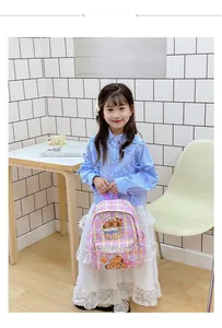 Detail view of large capacity purple plaid school bag with cute capybara print for kids
