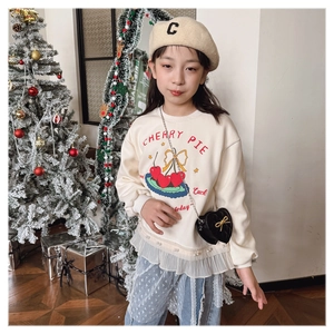 Detail of girls beige sweatshirt with cherry print and mesh hem with pearl accents