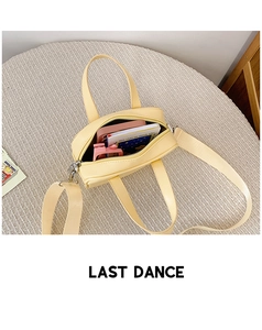 Top view of cream yellow plaid handbag showing interior storage space and shoulder strap