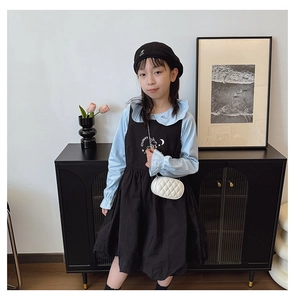 Detail of girls two-piece set featuring blue shirt with embroidered cloud collar details