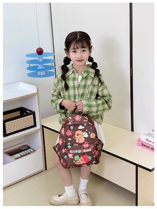 Detail view of large capacity kids backpack with cute cartoon capybara and floral prints