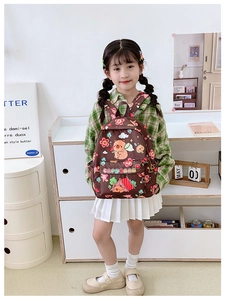 Girl wearing a brown Capybara backpack with cartoon prints and a side pocket