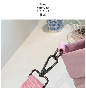 Detail of pink canvas bag featuring gunmetal swivel lobster clasp and D-ring hardware