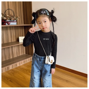 Kids white mini crossbody bag with heart lock styled with a denim bow print outfit