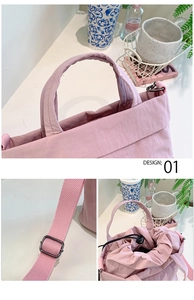 Detail of pink nylon crossbody bag showing the adjustable strap and drawstring closure