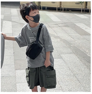 Street style kids canvas crossbody bag paired with cargo shorts and gray t-shirt