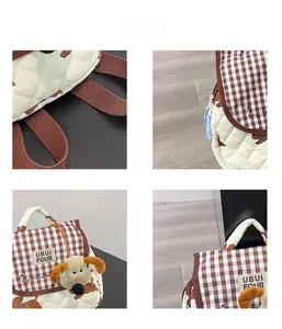Detail view of quilted fabric, gingham accents, and plush puppy charm on a child backpack