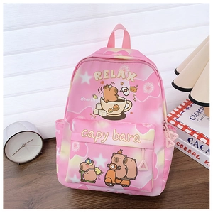 Pink school bag with Capybara print on a desk with a vintage clock and books