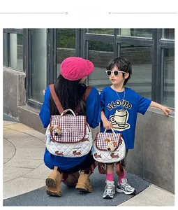 Outdoor shot of quilted mother and child backpacks with puppy pendant and check pattern