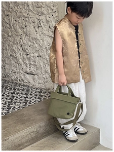Close-up of military green canvas toddler tote bag with round logo detail on the side