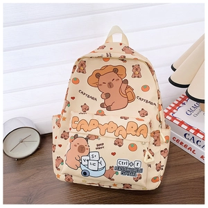 Detail of cute capybara print backpack showing multi-pocket storage on a wooden desk