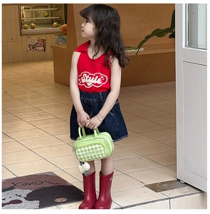 Close-up of a mint green checkered handbag for girls styled with a summer outfit