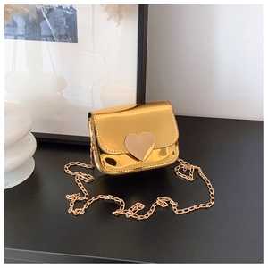 Detail of mini gold chain bag with heart buckle and metallic mirror finish for kids