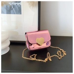 Detail of pink metallic mini crossbody bag with golden heart buckle and chain strap