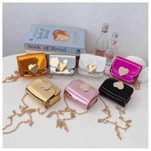 Detail of mini metallic crossbody bags with heart-shaped metal buckles and chain straps