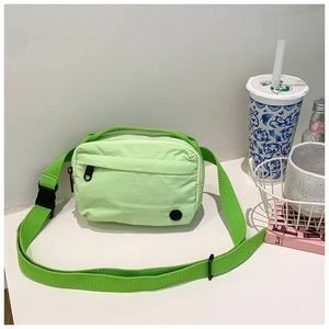 Detail of mint green nylon kids crossbody bag with adjustable green shoulder strap
