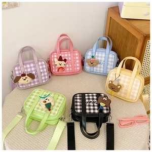 Detailed assortment of colorful plaid mini kids bags with cute cartoon animal pendants