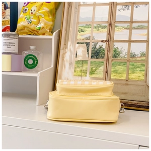 Detail of yellow gingham kids shoulder bag with silver D-rings on a clean tabletop