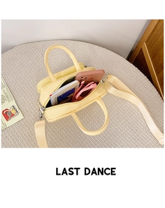 Detail view of cream mini bag showing internal capacity for phone and accessories