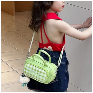 Detail view of mint green plaid kids shoulder bag with cute cloud plush charm