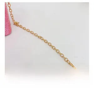 Macro shot of glittery pink texture and polished golden chain strap on a kids handbag