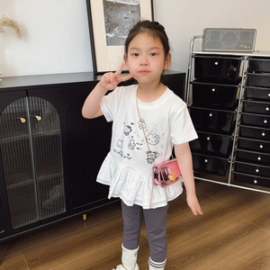 Toddler girl wearing white ruffle tee with pink heart-shaped metallic chain crossbody bag