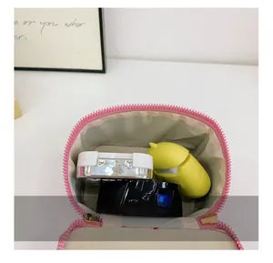 Detail showing the internal storage capacity of the pink sequin crossbody box bag