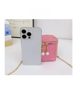 Detail of pink sequin mini crossbody bag with pearl charms and gold chain strap