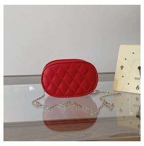 Detail view of red quilted oval chain bag with elegant diamond stitching and gold strap