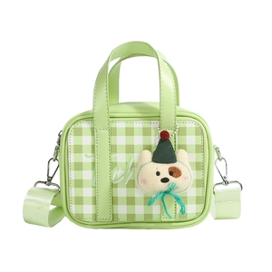 Green checkered mini kids handbag with dog charm and adjustable wide shoulder strap