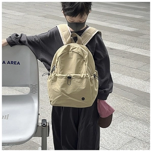 Detailed outdoor shot of the khaki waterproof school bag with adjustable drawstrings