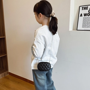Classic black quilted chain shoulder bag for kids with oval shape and silver metal strap