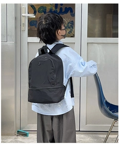 Detail view of the padded shoulder straps and durable nylon fabric on children's backpack