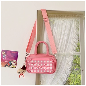 Pink checkered kids shoulder bag with plush cat charm and adjustable fabric strap
