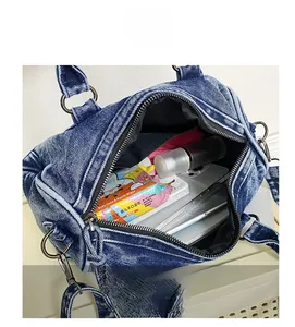 Internal capacity of the vintage denim hobo bag showing daily essentials and storage