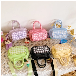 Detail of macaron-colored mini handbags with checkered patterns and cute cartoon charms