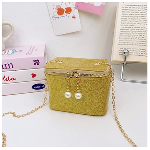 Close-up of sparkling gold sequin crossbody bag with luxury pearl zipper and chain strap