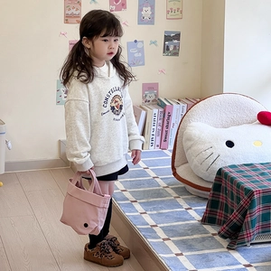 Classic gray hoodie for kids featuring retro Donald Duck print in a cozy home setting