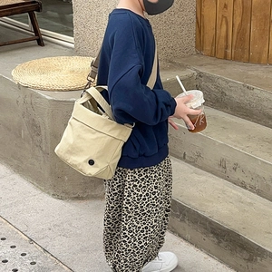 Minimalist cream canvas tote bag for children with adjustable shoulder strap for casual wear
