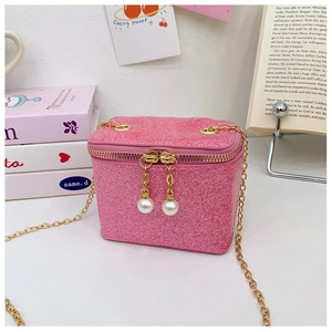 Detail of pink sequin mini crossbody bag with golden chain strap and pearl charm