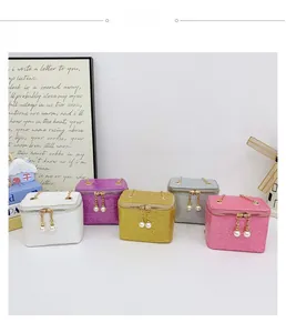 Detail of colorful sequin mini bags for kids with golden chains and pearl pendants