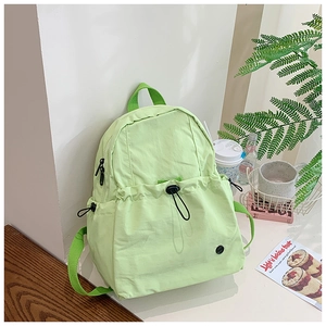 Detail of mint green school backpack with adjustable drawstring and sleek black buckle