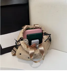 Interior view showing the large capacity of this khaki drawstring shoulder bucket bag