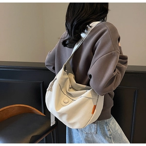 Detail of off-white hobo bag showing high-density canvas texture and orange brand label