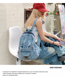 Detail of washed denim backpack with multi-pocket design and metal buttons for street style