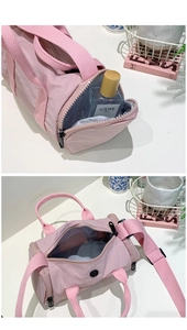 Pink nylon barrel shoulder bag showing interior storage and lightweight waterproof fabric