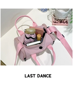 Interior view of pink cylinder shoulder bag showing space for umbrella and wallet