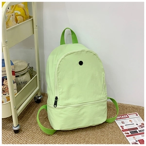 Close-up of the pastel green kid's backpack featuring durable nylon fabric and front pocket