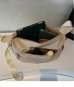 Top view of large capacity canvas crossbody bag showing spacious interior for tablets