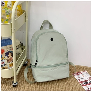 Detail view of mint green minimalist kids backpack with sturdy zipper and reinforced handle